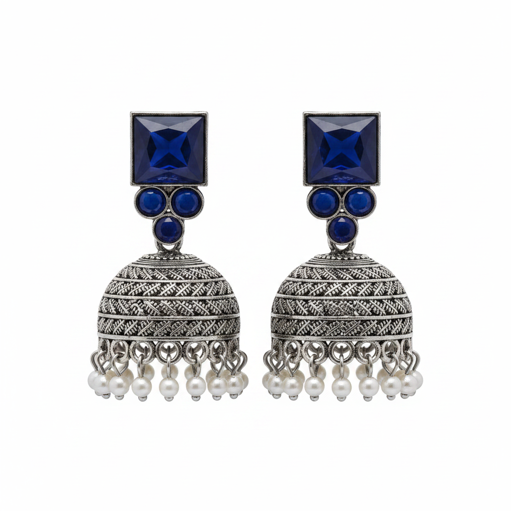 Oxidized silver navy blue sapphire jhumka earrings with pearl drops on white background