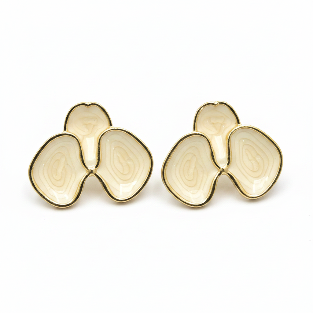 Cream enamel abstract petal stud earrings with gold border on white background