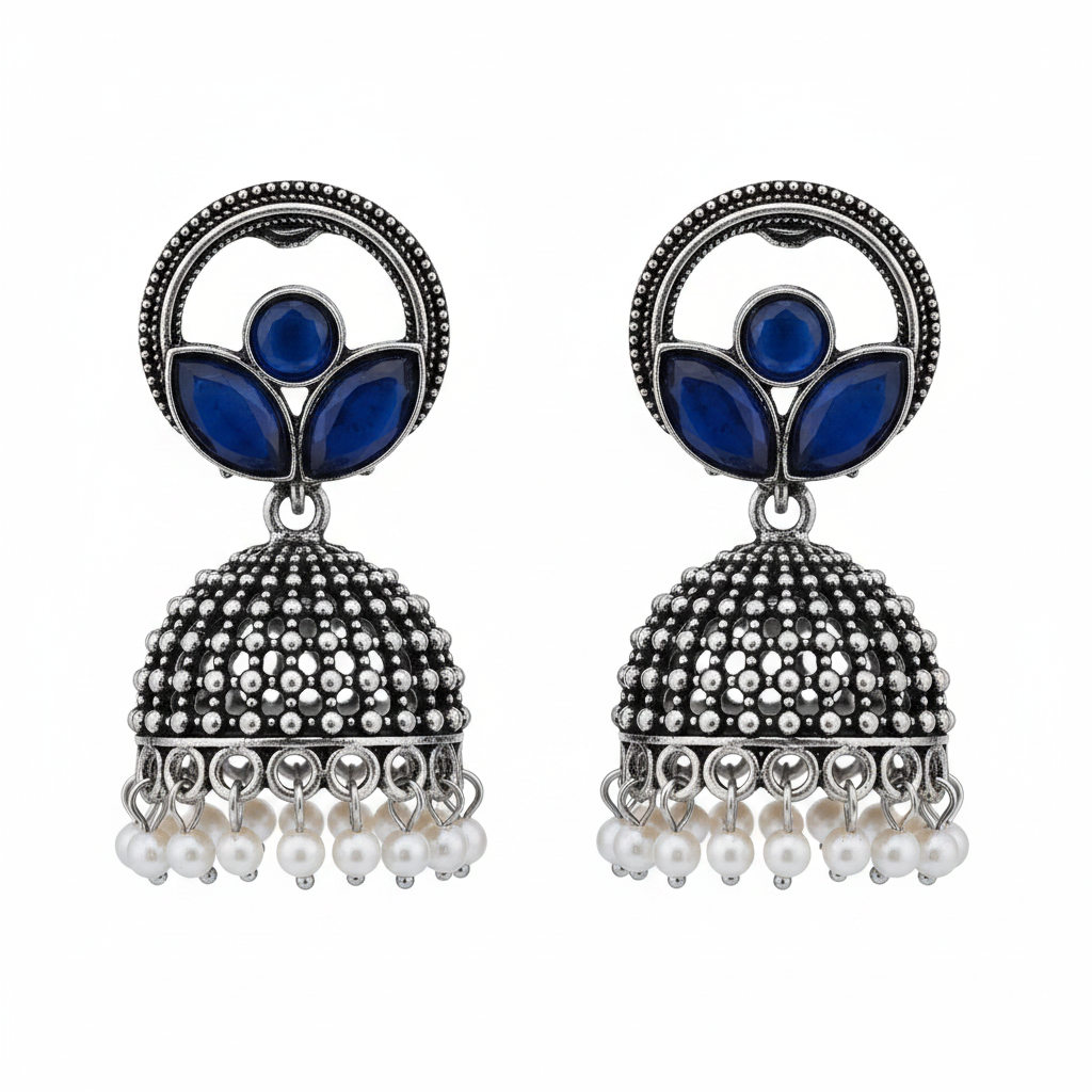 Oxidized silver blue stone paisley jhumka earrings with pearl drops on white background