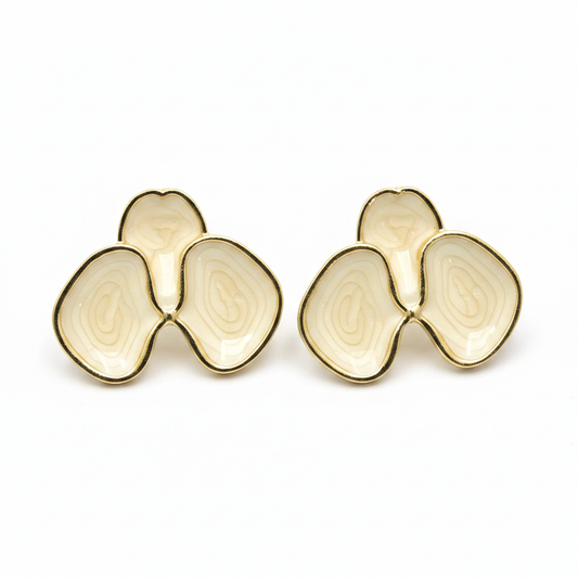 Cream enamel abstract petal stud earrings with gold border on white background