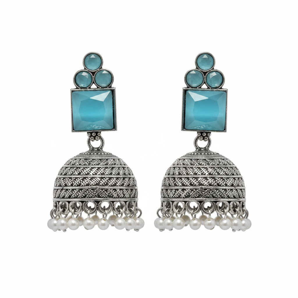 Oxidized silver aqua blue cat eye stone jhumka earrings with pearl drops on white background